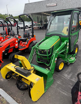 USED 2016 JOHN DEERE 1025R SUB-COMPACT TRACTOR / 24 HP YANMAR DIESEL /  HEATED CURTIS CAB / 54" DRIVE-OVER MID-MOWER / FRONT LOADER / 54" BUMPER SNOWBLOWER