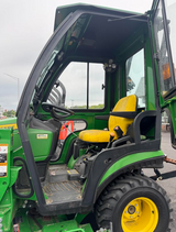 USED 2016 JOHN DEERE 1025R SUB-COMPACT TRACTOR / 24 HP YANMAR DIESEL /  HEATED CURTIS CAB / 54" DRIVE-OVER MID-MOWER / FRONT LOADER / 54" BUMPER SNOWBLOWER